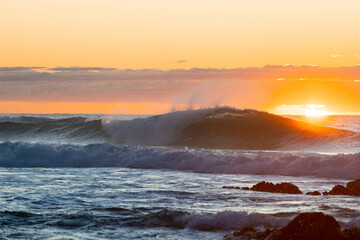 Beautiful blue wave in the ocean at sunrise time.