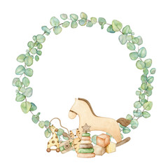 Baby shower frame with wooden toys pyramid, camera, rocking horse, cubes, plush tiger, giraffe on wheels, teething toy in eucalyptus wreath. Hand drawn watercolor illustration eco kids toys for card