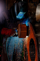 Steelworkers working with steelproducts at plant. welding and inspection - Wind turbine industry