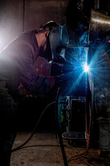 Steelworkers working with steelproducts at plant. welding and inspection - Wind turbine industry