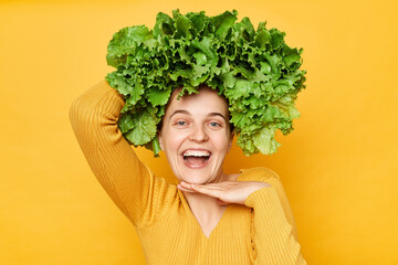 Healthy food, diet, vegetarian meal, dieting, weight loss. Smiling joyful cheerful woman with lettuce hair style with green vegetables on her head. Organic cooking.