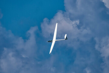 Glider plane flying in the clouds - 615091338
