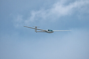 Glider plane flying in the clouds