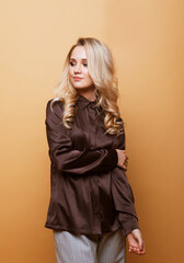 Fototapeta premium Beautiful young blond woman over beige background