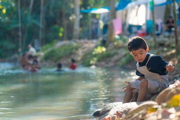 Happy kindergarten asian boy camping in forest camp site