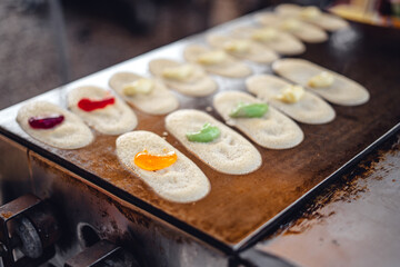 Vendors making sweets on hot stoves in the market