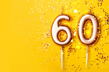 60 years celebration. Greeting banner. Gold candles in the form of number forty on yellow...