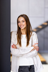 Positive serious woman looking at camera, posing in apartment.