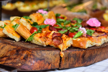 pepperoni pizza with tomatoes, arugula and edible flowers, sliced ​​pepperoni pizza, thanksgiving day, thanksgiving, thanksgiving meal, haute cuisine	