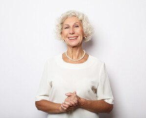 Grey haired old nice beautiful laughing woman. Isolated over white background.