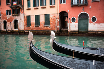 Fototapeta na wymiar Gondolas's embelish in a canal in Venice, Italy