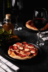 Pizza with wine, dark background
Iatllian food, dinner 