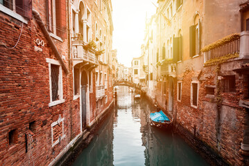 Obraz na płótnie Canvas Narrow canal in Venice, Italy with boats