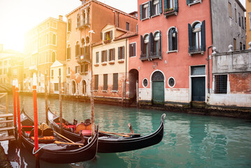 Fototapeta na wymiar Narrow canal in Venice, Italy with gondolas