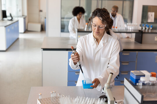Scientist pipetting samples into eppendorf tubes