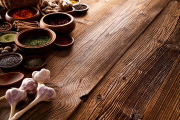 Spices. Collection of spices in bowls on wooden rustic table forming an abstract background.