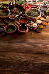 Spices. Collection of spices in bowls on wooden rustic table forming an abstract background.