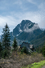 mountain view with a old mountain house in front; high hill and beautiful sky in polish tatry area Zakopane