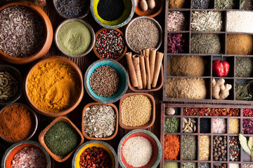 Spices. Collection of spices in bowls on wooden rustic table forming an abstract background.