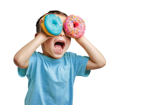 Naklejka Happy cute boy is having fun played with donuts on png background. Bright photo of a child.
