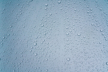 Background - water droplets on the surface of light blue color