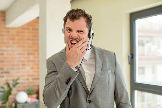 with mouth and eyes wide open and hand on chin. telemarketer concept