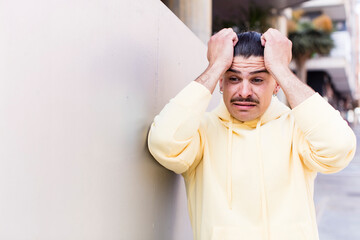 young cool man panicking over a forgotten deadline, feeling stressed, having to cover up a mess or...