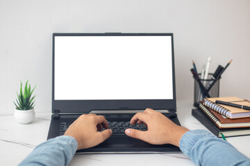 man's hands working on laptop at home desk