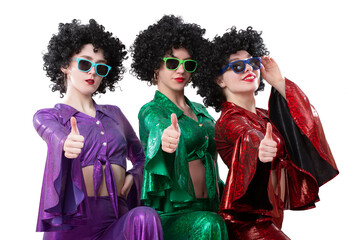 Disco style girls in colorful flared suits and African American wigs on a white background. Seventies or eighties style.