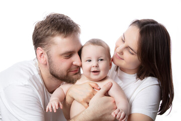 Close up portrait of young parents and baby. Father and mother kiss and hug a beautiful little son. The concept of love, happy fatherhood and motherhood.