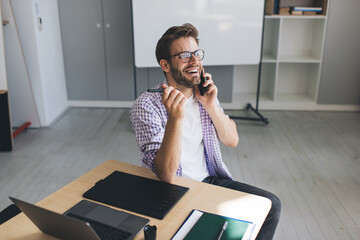 Millennial businessman working at desk in office