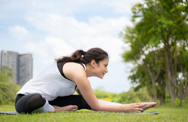 Young female with outdoor activities in the city park, Yoga is her chosen activity.