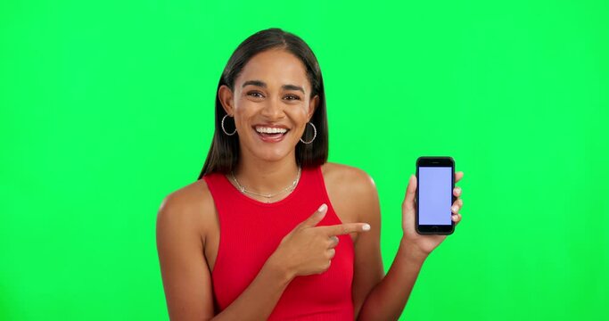 Woman, green screen and point at phone, face and mockup space for logo, branding or review with smile. Girl, model or young student with smartphone, pointing and happy for promotion with mobile app