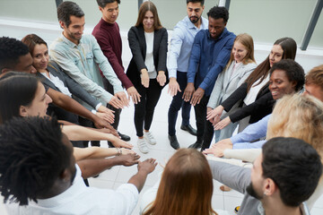 Obraz premium Narrow banner of multiracial people stack hands motivated for shared business success or goal achievement.