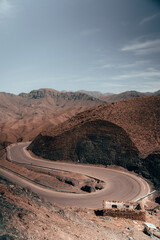 Curving through Atlas mountains, an intricate road winds, revealing the untamed beauty of the...