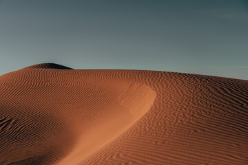 Nature's masterpiece: Intricate patterns sculpted by wind upon the desert sands, a captivating...