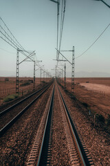 Train rails: Symbolic paths that stretch into the horizon, embodying adventure, anticipation, and limitless possibilities.