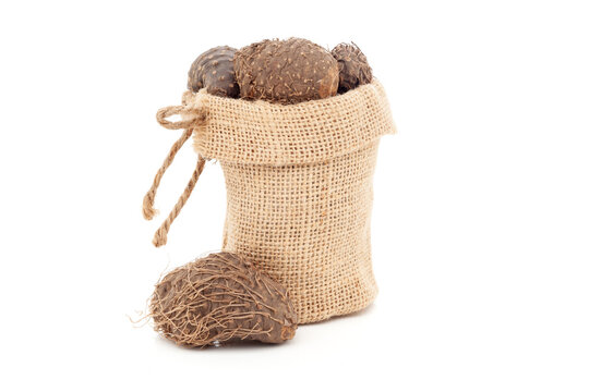 Close-up of Dry Organic Varahikanda (Dioscorea bulbifera) fruit, in a jute bag. Isolated over white background.