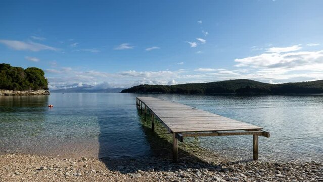 wooden pier on beach in corfu greece
