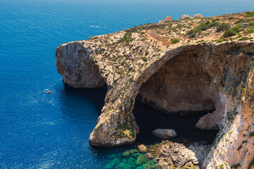 The famous arch of the Blue Grotto sea caves on the Island of Malta. Popular for tourists to enjoy boat trips to scenic location.