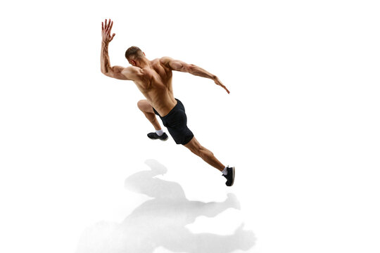 Sport achievements. Top view image of man, professional runner, athlete in motion against white studio background with shadow on floor