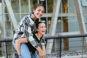 two teenage sisters in the city laughing and having a good time