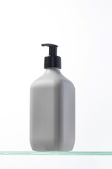 A mockup of a white dispenser with a cosmetic product for skin care of the face and body. Shower gel, facial cleanser.