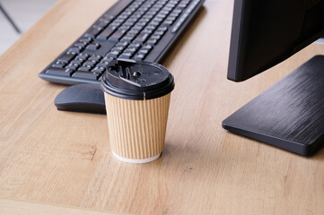 Laptop and coffee mugs on the desk.