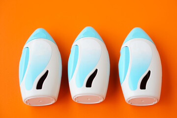 Three nasal spray suspension on orange background.  Concept, Pharmaceutical products for treatment symptoms of allergic rhinitis. Use under prescription. Health care medical device at home.   