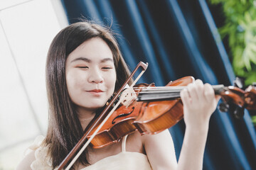 Violinist woman : Portrait of a young female playing the violin.
