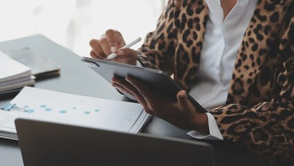 Asian Business woman using calculator and laptop for doing math finance on an office desk, tax, report, accounting, statistics, and analytical research concept - Powered by Adobe
