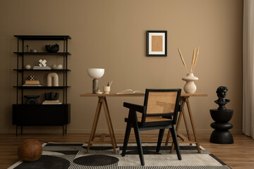 Elegant composition of workplace interior with mock up poster frame, wooden desk, rattan chair,...