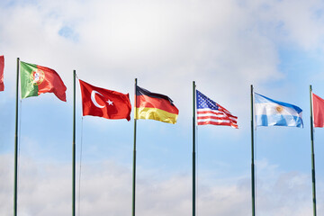 Germany, USA, Turkey, Portugal and Argentina flags on sky