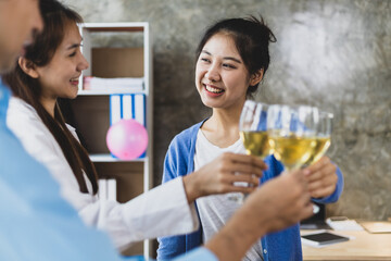 Cheers, clink glasses, Friends having a drink to celebrate at a small party in their home office.